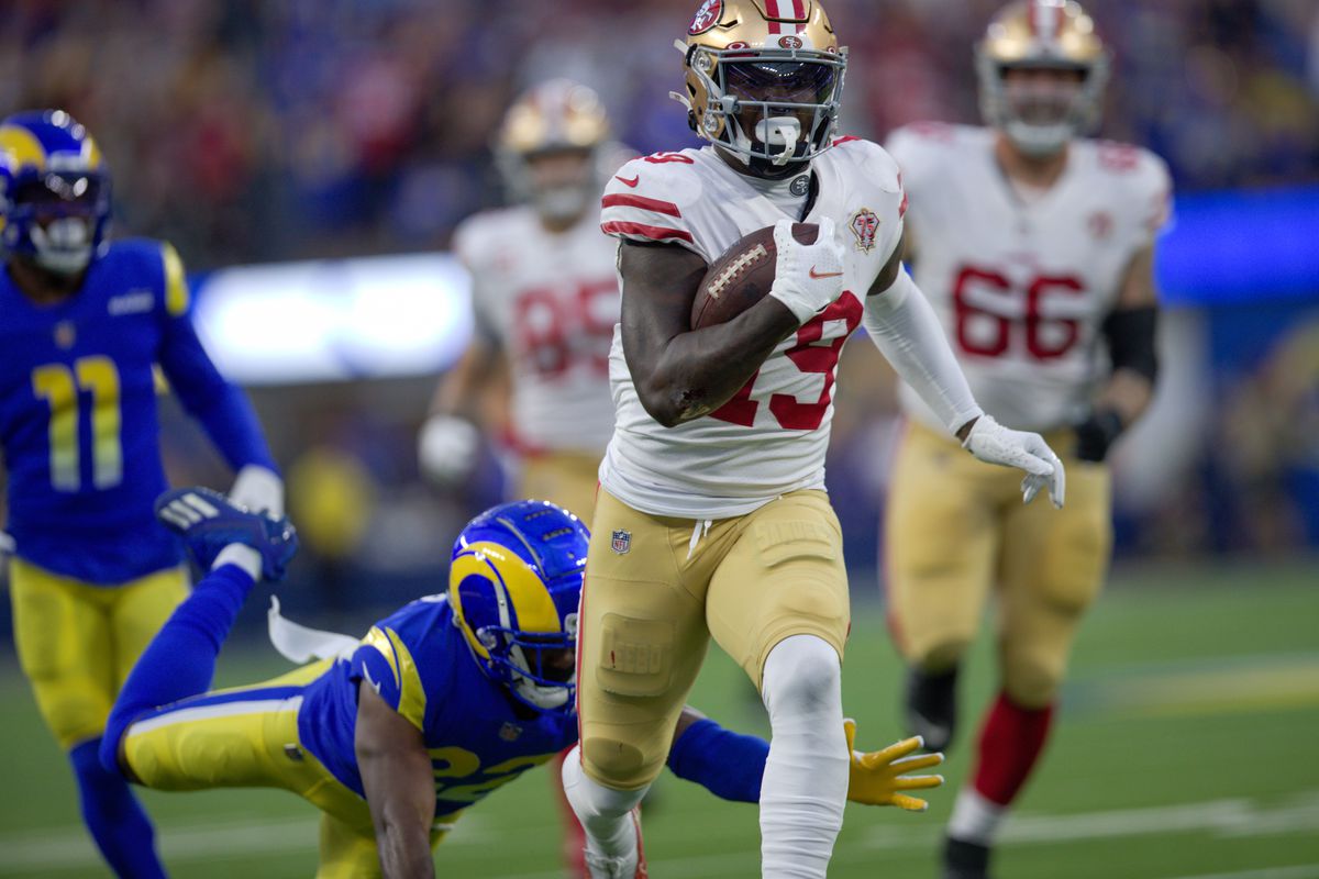 Deebo Samuel #19 of the San Francisco 49ers heads to the end zone on a 44-yard touchdown catch during the game against the Los Angeles Rams at SoFi Stadium on January 30, 2022 in Inglewood, California. The Rams defeated the 49ers 20-17.