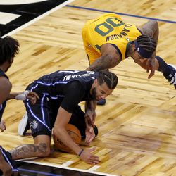 Orlando Magic guard Michael Carter-Williams and Utah Jazz guard Jordan Clarkson try to get possession of the ball during the second half of an NBA basketball game Saturday Feb. 27, 2021, in Orlando, Fla. 