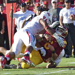 Cody Kessler takes a hard hit from Todd Hunt.