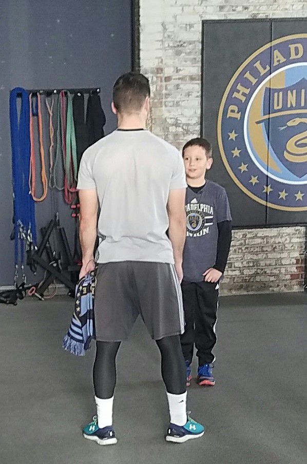 The Philadelphia Union’s Keegan Rosenberry and fan Ethan Chambers meet at the Power Training Complex.