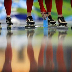 A Norwegian speedskater picks up a drink while training for the team pursuit at the Richmond Olympic Oval at the Vancouver 2010 Olympics on Thursday.