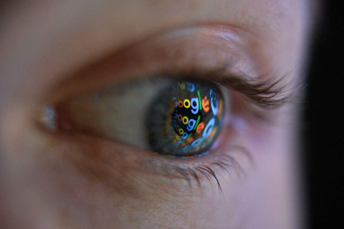 An eyeball with the Google logo reflected in it.