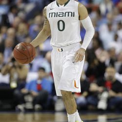 Miami's Shane Larkin (0) brings the ball up the court against North Carolina State during the first half of an NCAA college basketball game at the Atlantic Coast Conference tournament in Greensboro, N.C., Saturday, March 16, 2013. 