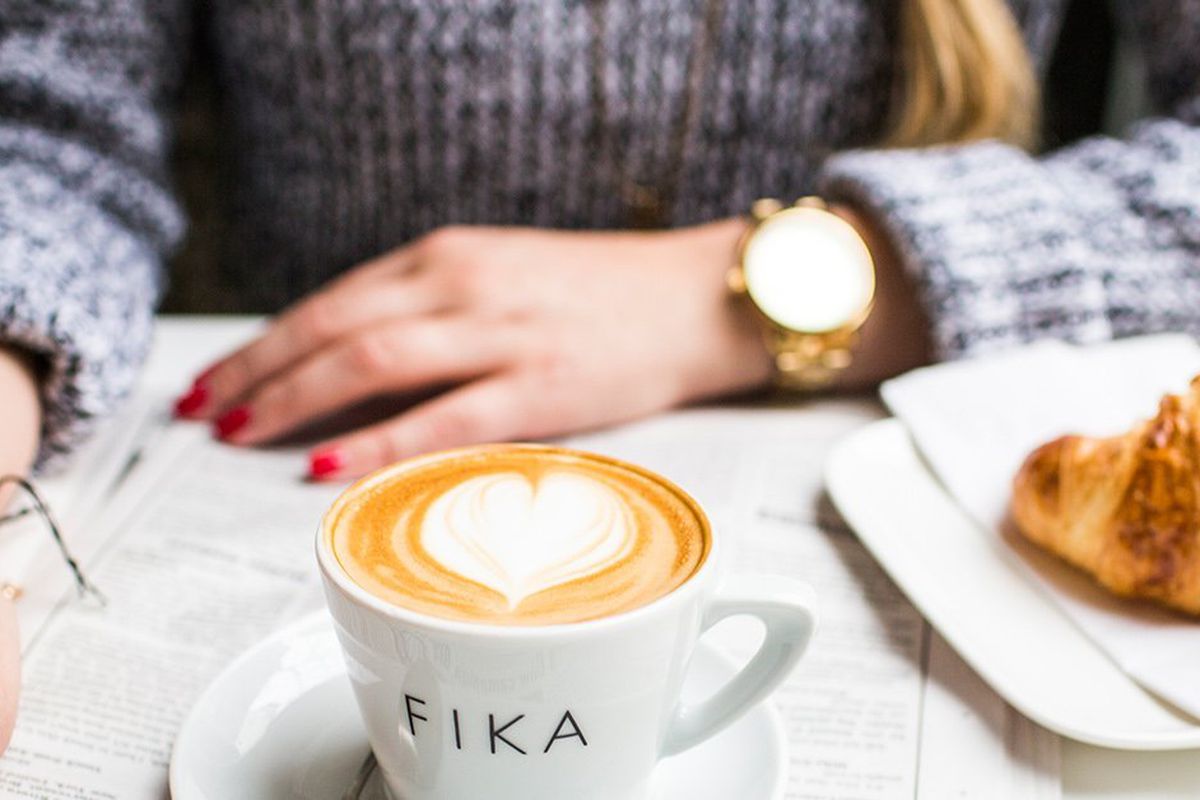 A coffee cup with the words “Fika” written across it