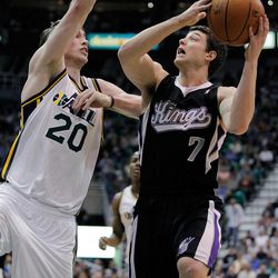Sacramento Kings guard Jimmer Fredette (7) looks to shoot while defended by Utah Jazz forward Gordon Hayward (20) during the first half of their NBA basketball game in Salt Lake City, Friday, March 30, 2012.  (AP Photo/Steve C. Wilson)