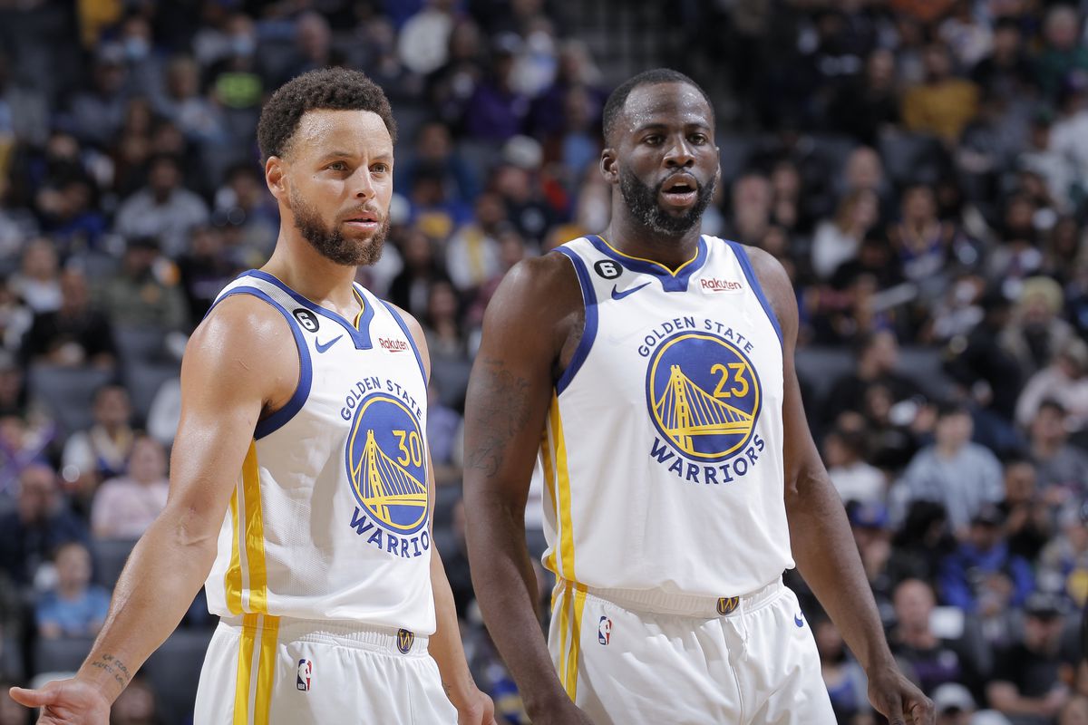 Steph Curry and Draymond Green standing next to each other looking confused