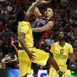 Arizona guard Gabe York shoots over Oregon forward Jordan Bell, left, during the first half of an NCAA college basketball game in the semifinal round of the Pac-12 men's tournament Friday, March 11, 2016, in Las Vegas. 