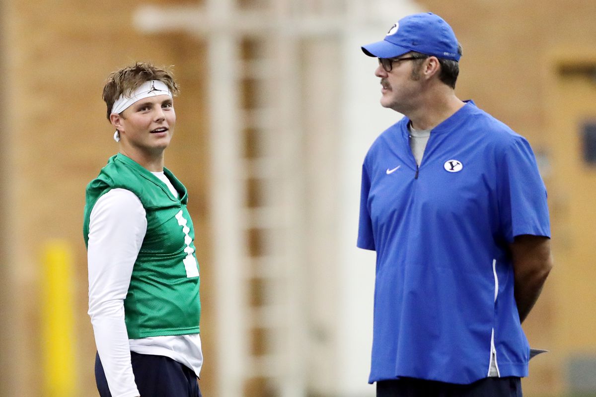 Quarterback Zach Wilson walks near offensive coordinator Jeff Grimes as BYU opens football practice at the indoor facility in Provo on Wednesday, July 31, 2019. In a Zoom meeting last month, Grimes said BYU has three quarterbacks capable of leading the offense in 2020.