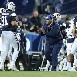 Brigham Young Cougars head coach Kalani Sitake cheers for his players after a fourth down stand as BYU and Hawaii play at LaVell Edwards Stadium in Provo on Saturday, Oct. 13, 2018. BYU won 49-23.