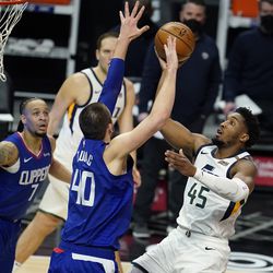 Utah Jazz guard Donovan Mitchell (45) shoots over Los Angeles Clippers center Ivica Zubac (40) during the first half of an NBA basketball game Wednesday, Feb. 17, 2021, in Los Angeles. 