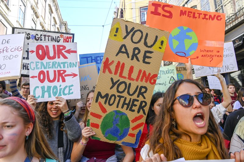 Portuguese students chant and hoist placards in front of the Assembleia da Republica (Portuguese Parliament) during their demonstration to support actions for climate change on March 15, 2019 in Lisbon, Portugal. 