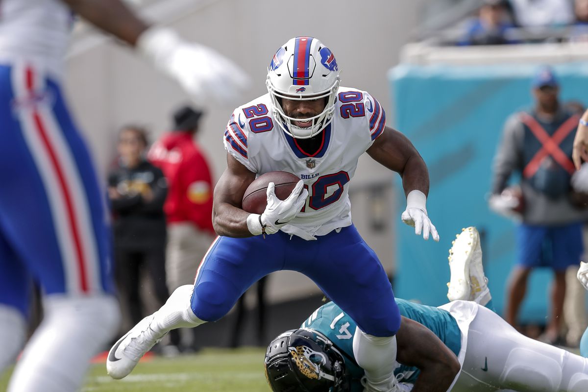 Running back Zack Moss #20 of the Buffalo Bills is tackled by the ankles by Linebacker Josh Allen #41 of the Jacksonville Jaguars during the game at TIAA Bank Field on November 7, 2021 in Jacksonville, Florida.