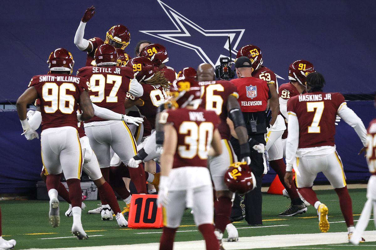 Montez Sweat #90 of the Washington Football Team celebrates with his teammates after an interception for a touchdown during the fourth quarter of a game against the Dallas Cowboys at AT&amp;T Stadium on November 26, 2020 in Arlington, Texas.