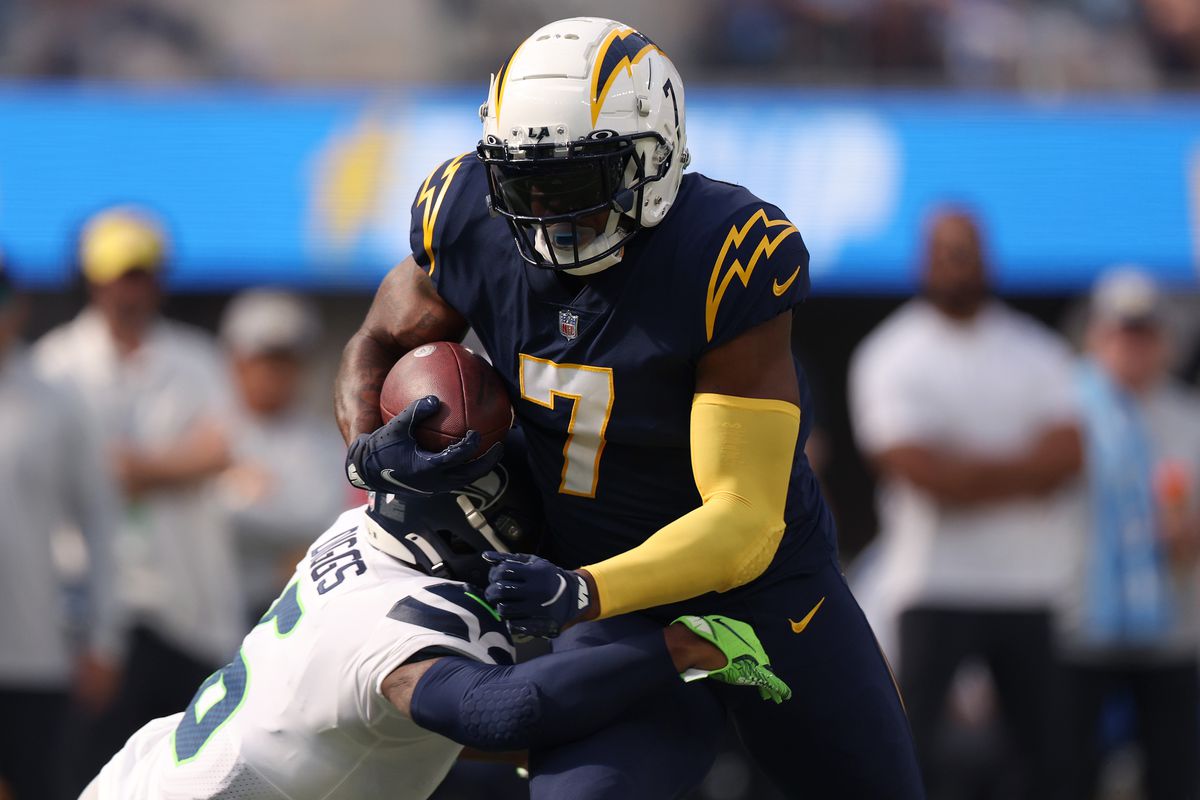 Gerald Everett #7 of the Los Angeles Chargers is tackled by Quandre Diggs #6 of the Seattle Seahawks during the second quarter of the game at SoFi Stadium on October 23, 2022 in Inglewood, California.
