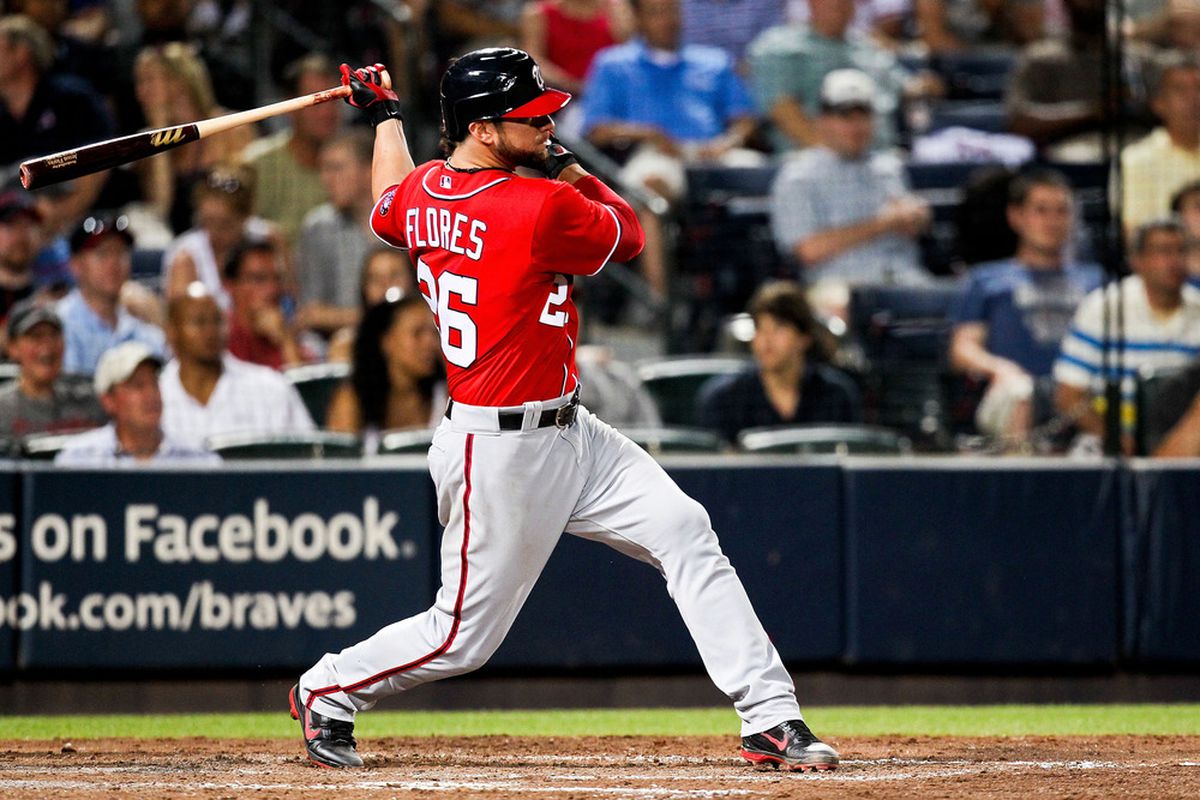May 27, 2012; Atlanta, GA, USA; Washington Nationals catcher Jesus Flores (26) drives in a run in the fourth inning against the Atlanta Braves at Turner Field. Mandatory Credit: Daniel Shirey-US PRESSWIRE