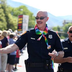 Salt Lake City Police Chief Chris Burbank and police officers hand out stickers during the 2015 Utah Pride Festival Parade in Salt Lake City on Sunday, June 7, 2015. Burbank resigned Thursday, June 11, 2015.