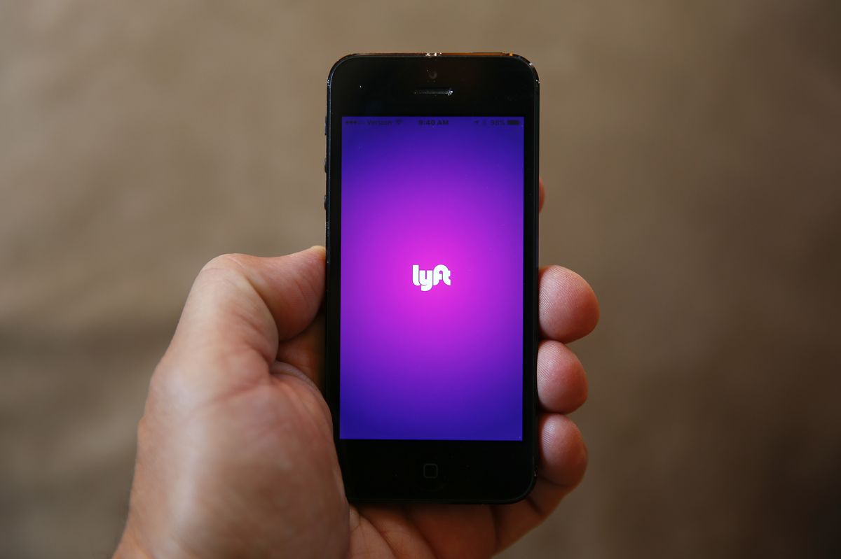 FILE - This Monday, May 16, 2016, file photo shows a smartphone displaying the Lyft app, in Detroit. The next Lyft car you book may soon be a Jaguar or a Land Rover.
