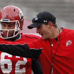 A.J. Merlino gets instruction from coach Jay Hill during University of Utah football practice on April 16 in Salt Lake City.