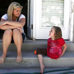 Erin Herrin talks to daughter Kendra outside their North Salt Lake home. Kendra was separated from her twin, Maliyah, four years ago.