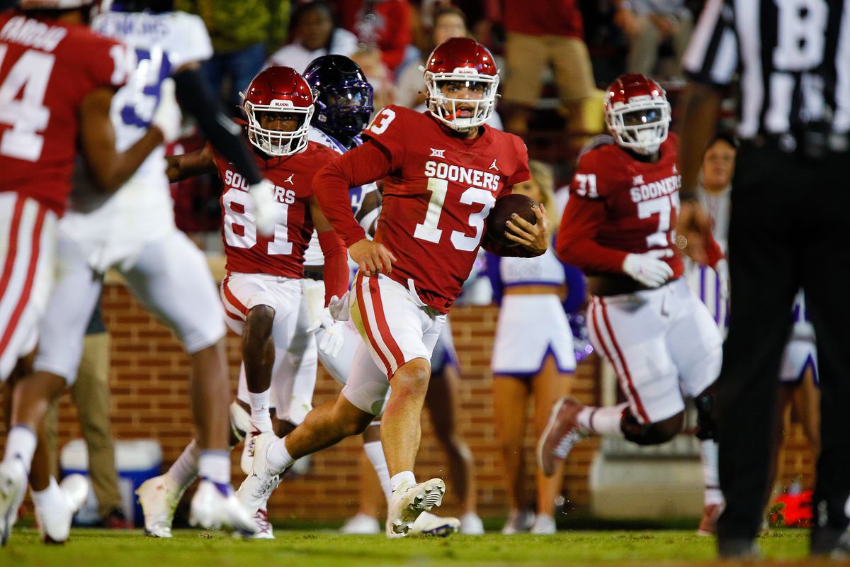 Quarterback Caleb Williams of the Oklahoma Sooners weaves his way to a 41-yard touchdown against the Texas Christian University Horned Frogs in the third quarter at Gaylord Family Oklahoma Memorial Stadium on October 16, 2021 in Norman, Oklahoma.