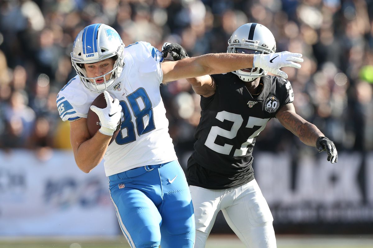 Detroit Lions tight end T.J. Hockenson runs after a catch next to Oakland Raiders cornerback Trayvon Mullen in the second quarter at Oakland Coliseum.