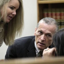 Martin MacNeill talks with his defense lawyer Susanne Gustin, left, in 4th District Court in Provo, Thursday, Oct. 31, 2013. MacNeill is charged with murder in the death of his wife, Michele MacNeill, in 2007.