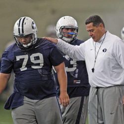 Offensive coordinator Robert Anae with lineman Manaaki Viatai on the first day of BYU football's spring camp Monday, March 4, 2013, in Provo