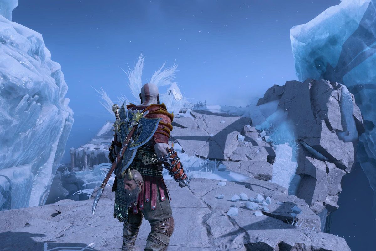 Kratos stares at an ice bridge in Niflheim leading to Tyr’s prison in God of War Ragnarok.