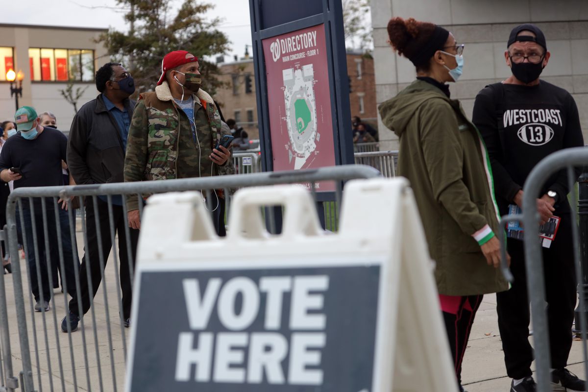 Voters wait in line to cast their ballots at an early voting center at Nationals Park October 27, 2020 in Washington, DC.