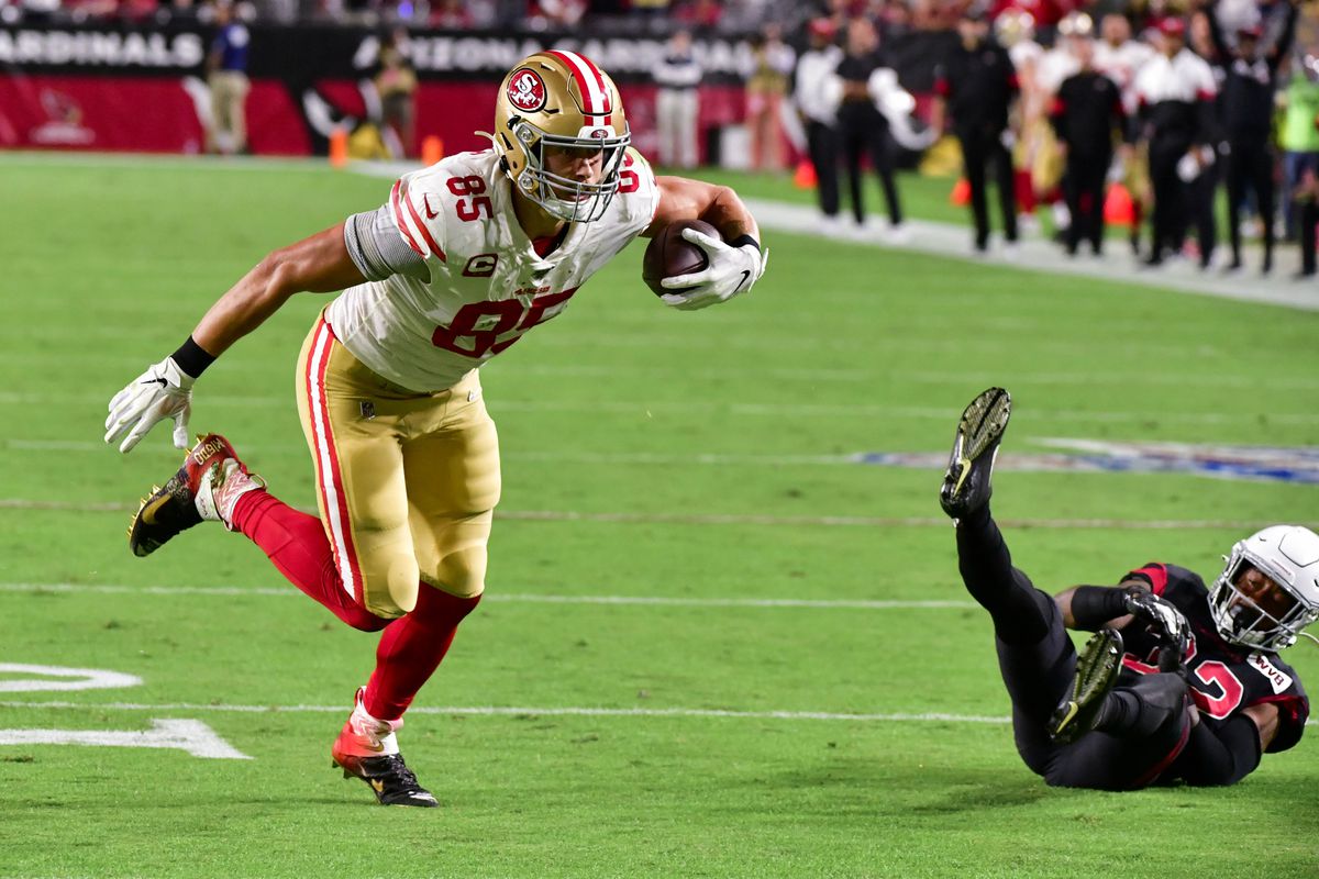 San Francisco 49ers tight end George Kittle knocks over Arizona Cardinals safety Budda Baker while running for a touchdown in the first quarter at State Farm Stadium.&nbsp;