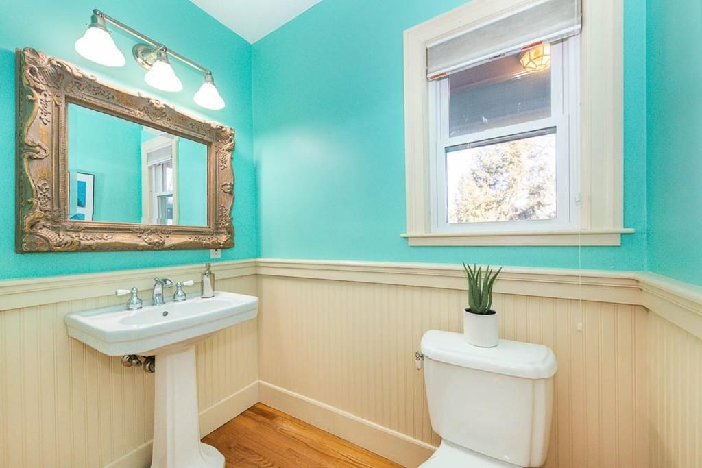 A small bathroom without a tub or a shower, but with starkly bright green walls.