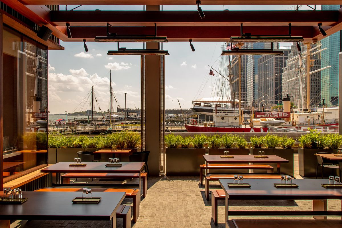 Patio seating at Bar Wayo has a view of boats in the water