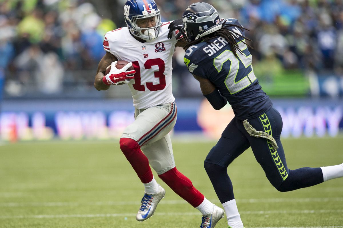 Odell Beckham tries to elude Richard Sherman