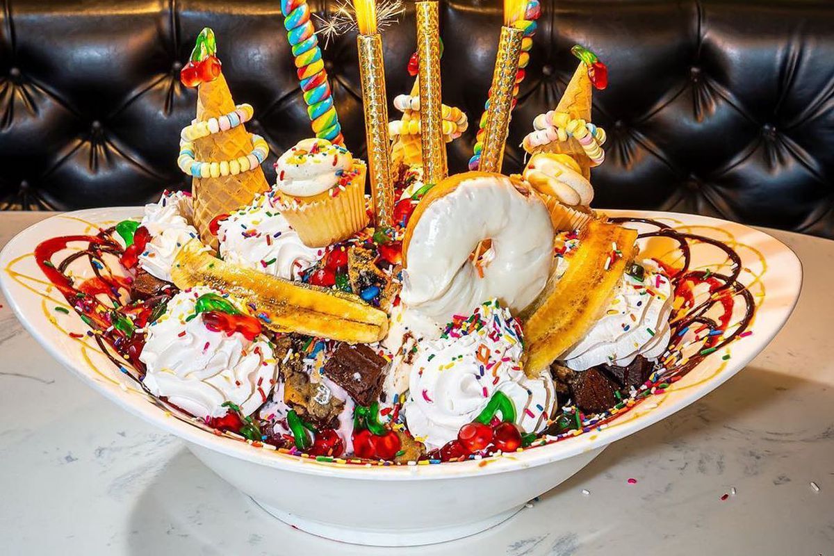 An outrageous ice cream sundae with sparklers on top