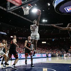 Arizona guard Devonaire Doutrive (center) lays in an easy basket past Oregon defenders during the Arizona-Oregon State game in McKale Center on January 19 in Tucson, Ariz.