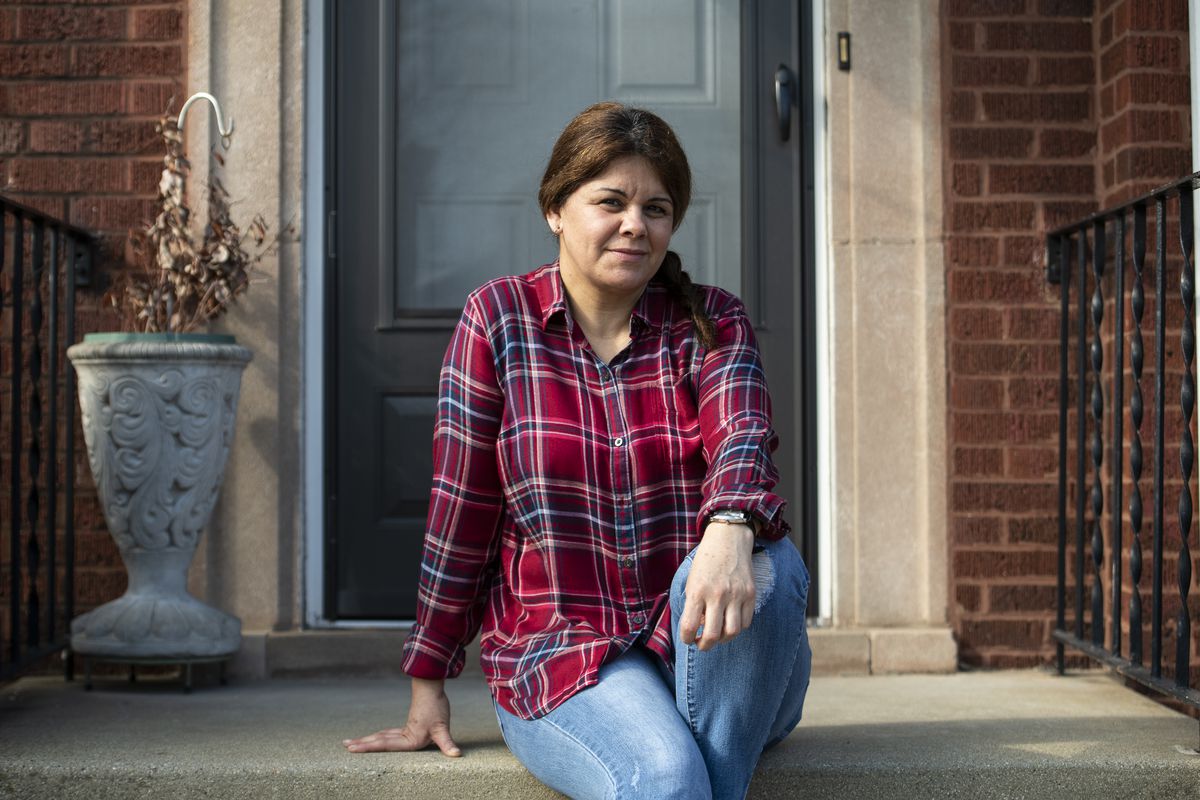 Manuela Sepulveda, a home health aide for elderly people, sits at her home in Gage Park, Tuesday, April 7, 2020.