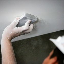 A drywall worker sands a section of drywall prior to painting inside the Vivint Smart Home Arena in Salt Lake City on Thursday, Aug. 24, 2017. The arena is undergoing a $125 million remodel.