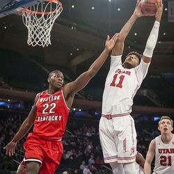 Utah Utes forward Chris Seeley (11) pulls in a defensive rebound over Western Kentucky Hilltoppers forward Dwight Coleby (22) as the Runnin' Utes take on the Western Kentucky Hilltoppers in the semifinal round of the 2018 NIT in Madison Square Garden in New York City on Tuesday, March 27, 2018.