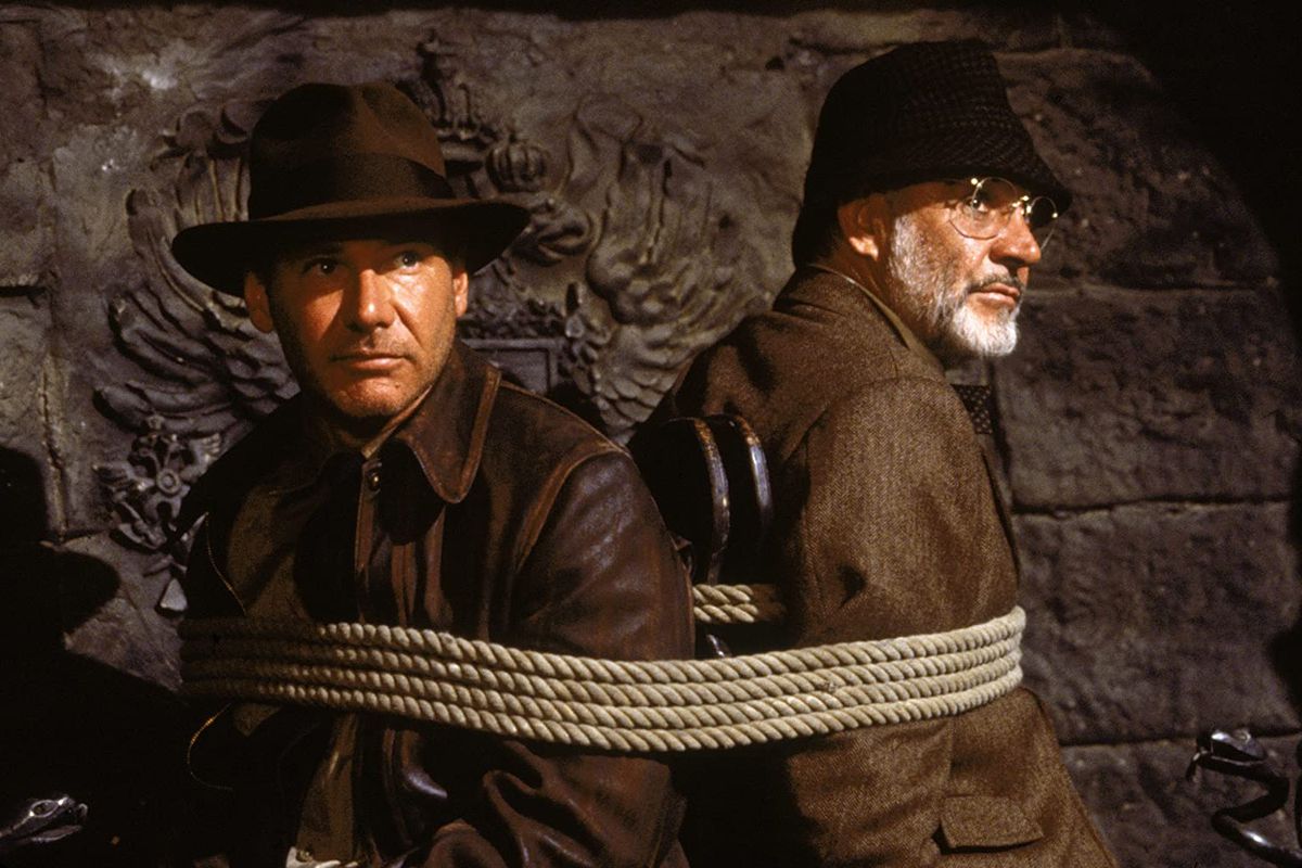 Indiana Jones (Harrison Ford) and Henry Jones (Sean Connery) are tied to a chair
