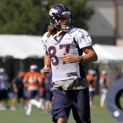 Broncos WR Jordan "Sunshine" Taylor lets his hair flow as he runs on the first day of Training Camp.