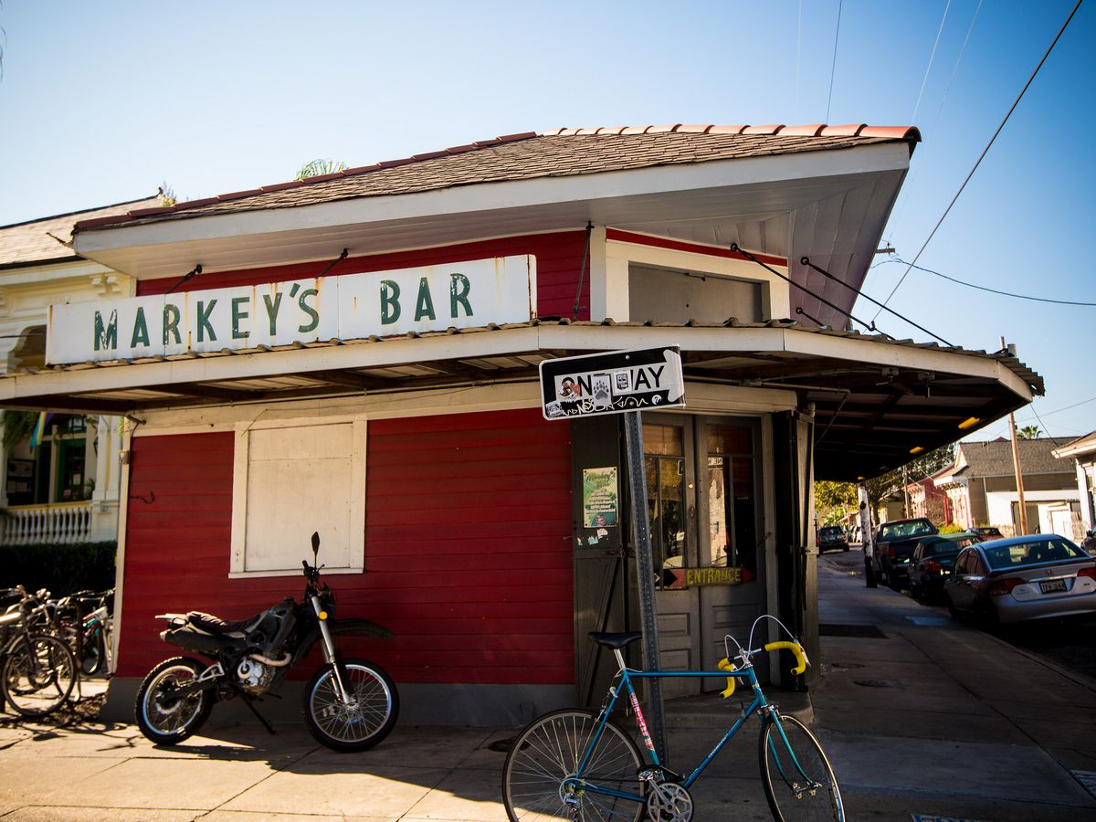 The exterior of Markey’s bar, a deep red building with a shabby white sign.