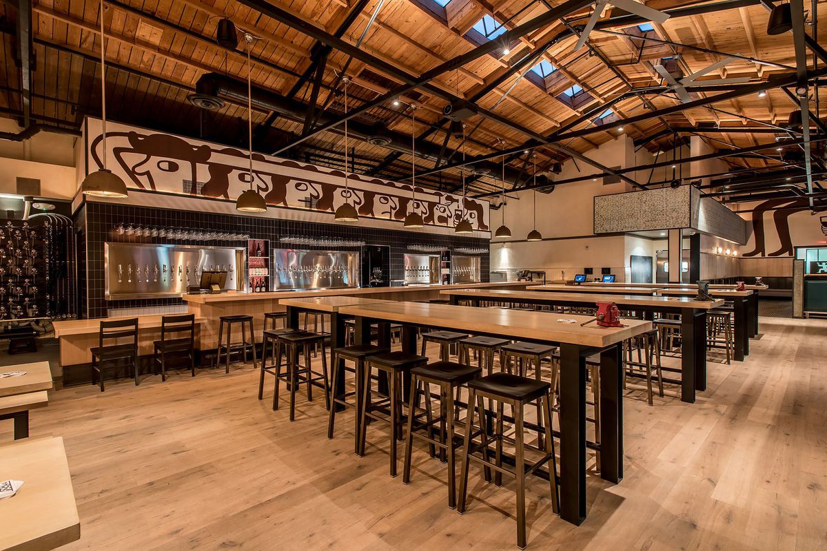A tall warehouse-like space for a craft beer bar.