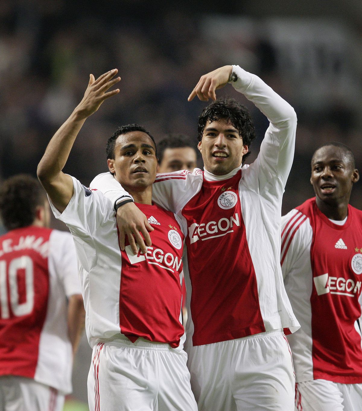 Ajax’ player Leonardo (L) is congratulat