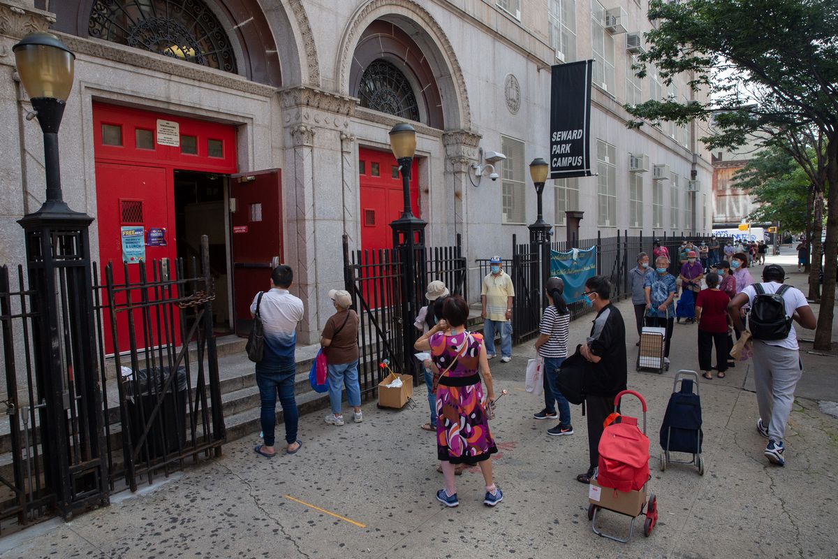 People pick up grab-and-go lunches from Seward Park Campus in the Lower East Side, Aug. 21, 2020.