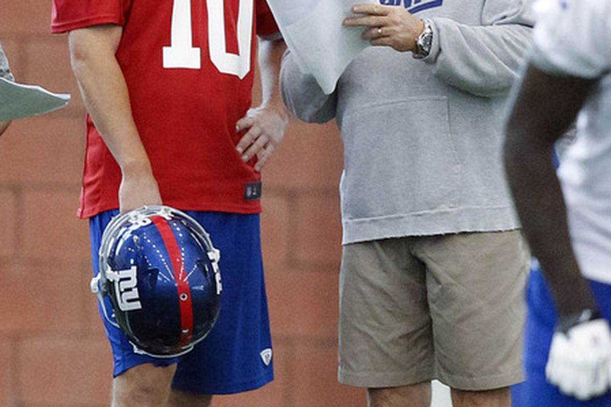 Jun 14, 2012; East Rutherford, NJ, USA;   New York Giants quarterback Eli Manning (10)  and offensive coordinator Kevin Gilbride during the Giants minicamp at their training facility. Jim O'Connor-US PRESSWIRE
