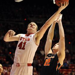 Utah Utes center Jeremy Olsen (41) is fouled by Oregon State Beavers center Angus Brandt (12) while going to the basket during a game at the Jon M. Huntsman Center on Saturday, Jan. 4, 2014.