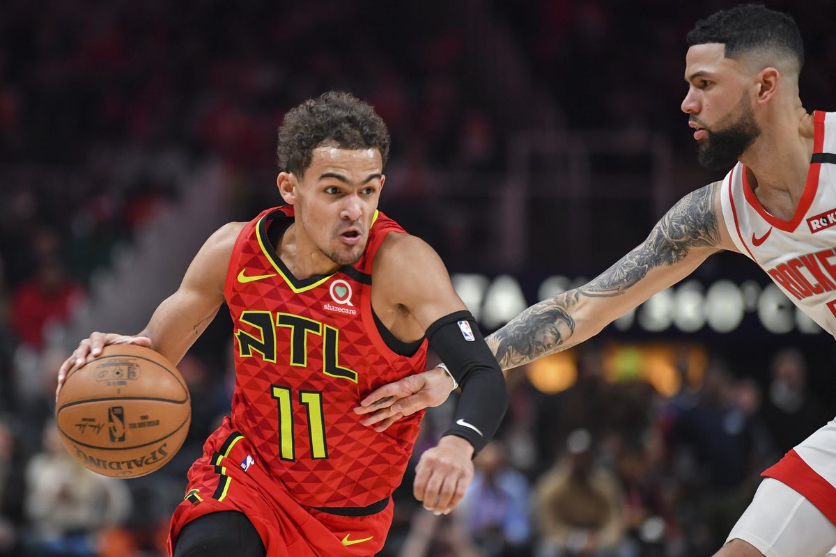 Atlanta Hawks guard Trae Young dribbles defended by Houston Rockets guard Austin Rivers during the second half at State Farm Arena.