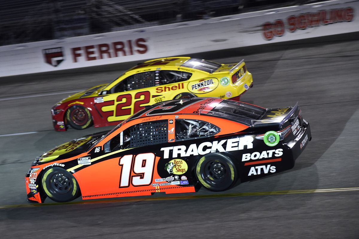 Martin Truex Jr., driver of the #19 Bass Pro Shops Toyota, and Joey Logano, driver of the #22 Shell Pennzoil Ford, race during the NASCAR Cup Series Federated Auto Parts 400 at Richmond Raceway on September 12, 2020 in Richmond, Virginia.