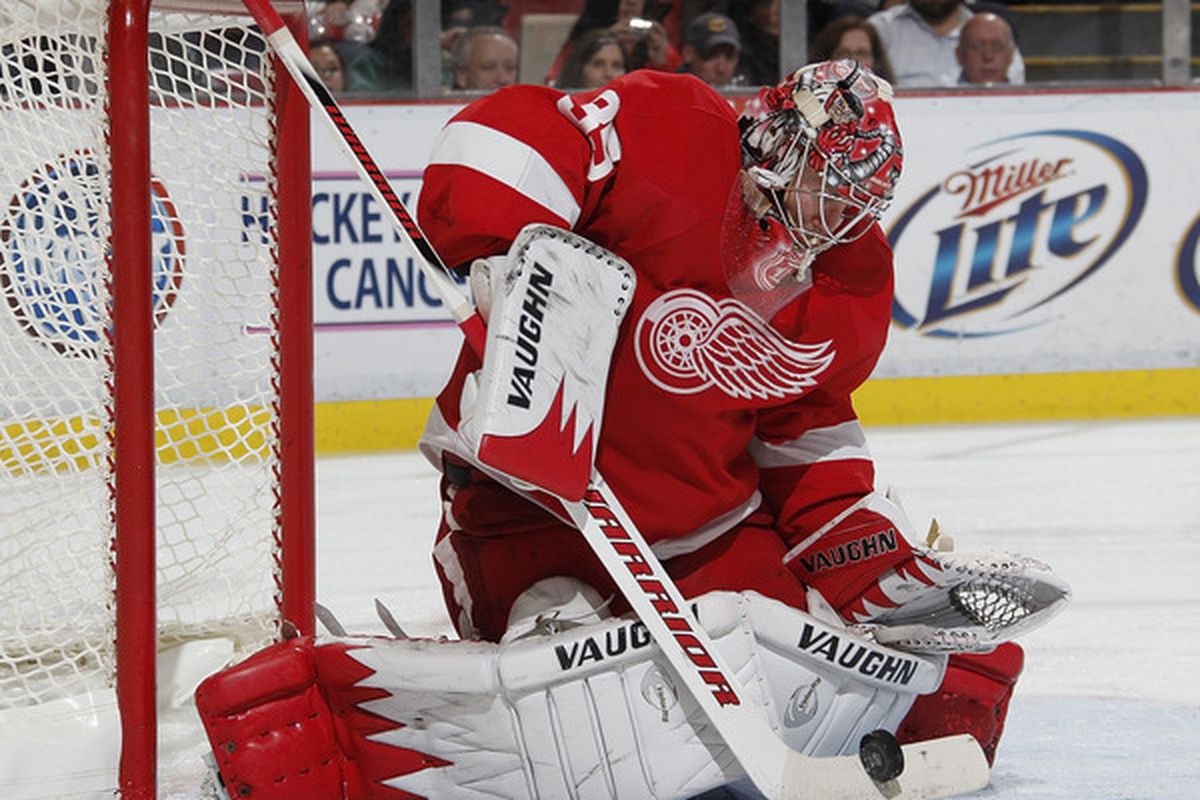 DETROIT - OCTOBER 21: Jimmy Howard #35 of the Detroit Red Wings makes a third period save while playing the Calfary Flames on October 21 2010 at Joe Louis Arena in Detroit Michigan. Detroit won the game 4-2. (Photo by Gregory Shamus/Getty Images)