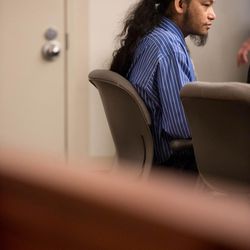 Esar met listens during his murder trial in Salt Lake City, Tuesday January 7, 2014. Met is accused of killing 7-year-old Hser Ner Moo in 2008